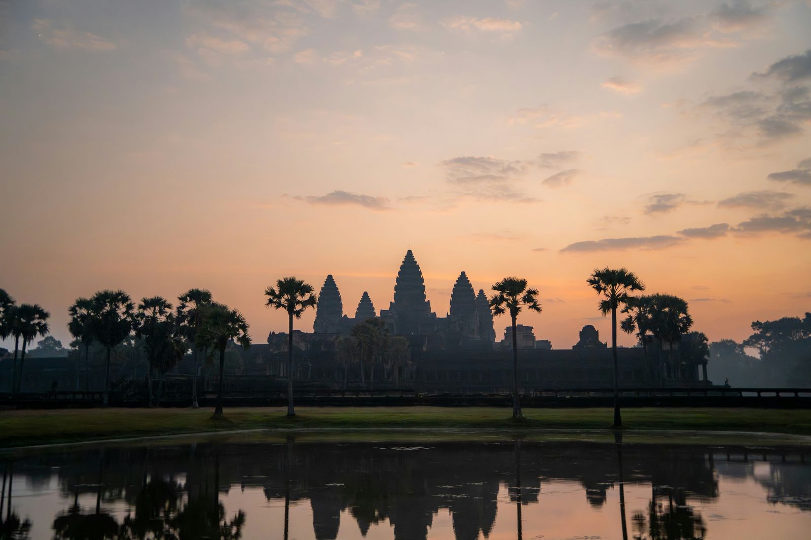 Angkor Wat reflected in water at sunrise near Siem Reap, Cambodia