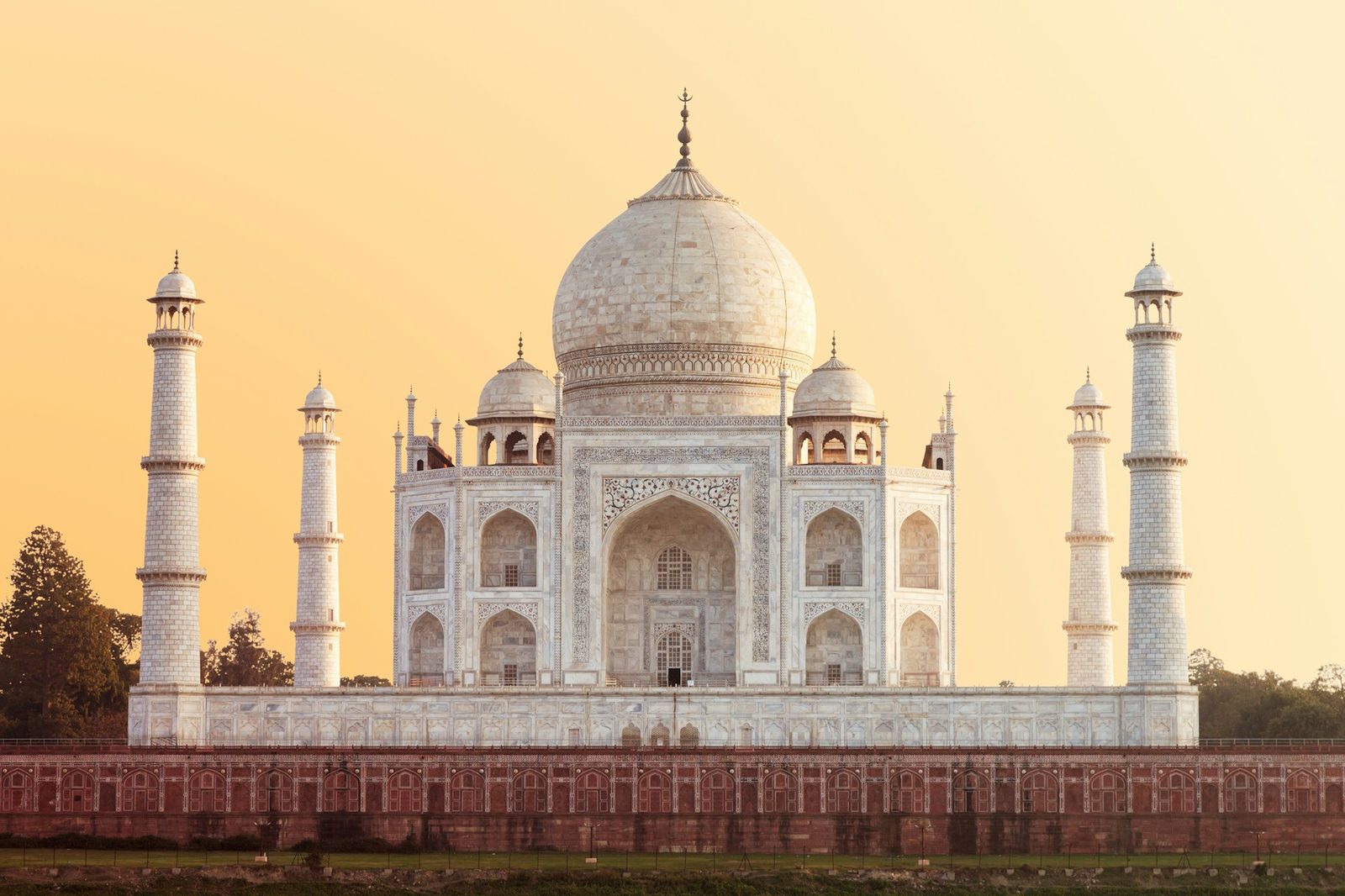 The Taj Mahal in Agra framed by a red sandstone archway